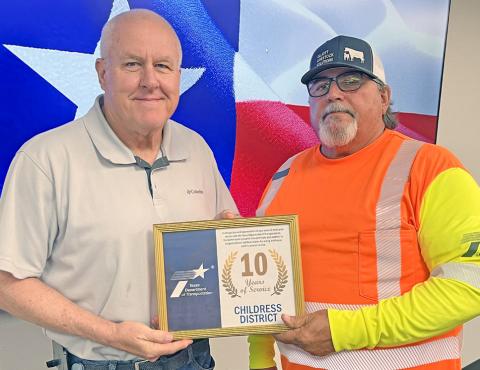 Texas Department of Transportation (TxDOT) Childress District Special Jobs Billy Hightower, right, accepts a 10year service award from TxDOT Childress District Engineer Darwin Lankford. Texas Department of Transportation