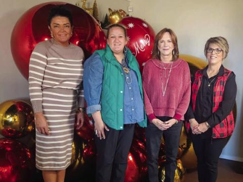 Host Brooke Carter, left, with Hearts United Give Support (HUGS) volunteers Whitney Wiebe, Marcy Sessions and Donnie Carter, welcome visitors for the Holiday Home Tour on Sunday afternoon, Dec. 7. Hearts United Give Support