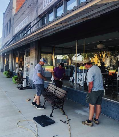 Wellington Community Fund board members Justin Mixon, left, Jimmy Cantu and Charlie Taylor install park benches Monday, June 24 on the Collingsworth County Courthouse Square. Not only a beautification project, the eight benches provide a place for rest and relaxation. Photo Courtesy of Karen Caldwell