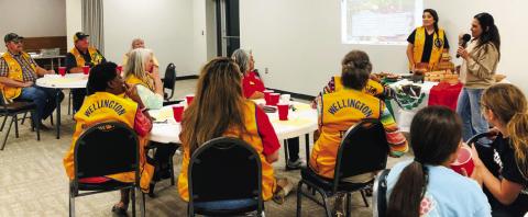 Maria Avalos, right, and Lion Noemi Pena encourage members of the Wellington Lions Club to embrace the colorful and beautiful diversity that Mexican Americans and all cultures bring to the United States. Avalos displayed kitchen items from Mexico that her mother uses daily. The Red River Sun/Bev Odom