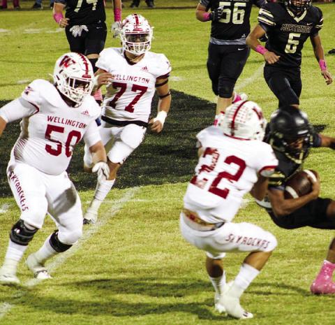 Skyrocket Enrique Jaimes (22) tackles a Mustang with Blake Strickland (50) and Rey Ramirez (77) also coming in, defensively shutting out the Mustangs in 64-0 final. Wellington moves to 7-1 overall and 3-0 in district play. The Red River Sun/Shauna Salinas