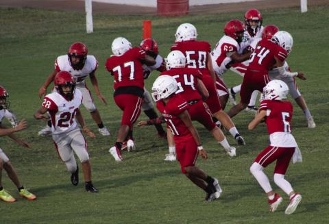 Wellington junior varsity Skyrocket Major Brown (6) attempts a pass with blocking by Kingston Molina (51), Yobani Moreno (77), Hunter Hedrick (54), Dixon Dugan (50) and KJ Molina (64) in the match against Borger Thursday, Oct. 5 at Powell Field. The Rockets moved to 6-0 overall, thanks to a big 40-0 win over the Bulldogs. The Red River Sun/Shauna Salinas
