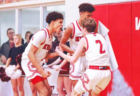 Wellington’s Brenden Garcia, left, celebrates with teammates after making a big play against Clarendon during a District 2-2A game Friday, Jan. 19. Press Pass Sports/James Abel