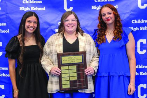 Head softball coach Amanda Wilson, center, awards Lady Cat Softball Offensive Most Valuable Player (MVP) Clarissa Gamboa, left, and Lady Cat Softball Defensive MVP Ansley Parr, right.