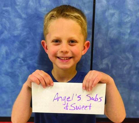 Kindergartener Will Patterson accepts the Angel’s Subs &amp; Sweets gift certificate on behalf of his mother, Abby Williams. Around 150 parents joined their children for lunch Friday, April 4 for Go Blue Day. Visitors registered for gift certificates provided by the restaurants and the Collingsworth County Child Protective Service Child Welfare Board. Wellington Elementary School