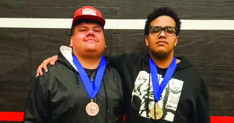 Memphis’ Mike Thomas, right, punches his ticket to the Texas High School Powerlifting Association State Championships, thanks to a first-place finish in weight class 275, during the Region 1 Division 4 Meet Thursday, March 6 in Brownfield. Teammate Eli Martin, left, finished third in the super heavy weight class, securing a spot as an alternate. Memphis ISD