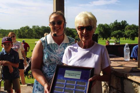 Childress Coordinator Abigail McGee accepts the Childress league Greenbelt Junior Golf Association Bill Beck Cup plaque from Belinda Beck. The Red River Sun/Elizabeth Tanner