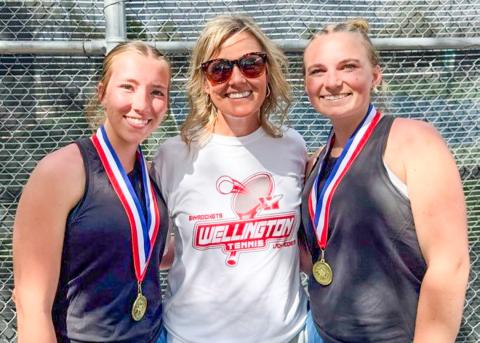Senior Lady Rocket cousins Brynlee Proffitt, left, and Oakley Folk, right, gather with Coach Amy Inman to celebrate the recent girls’ doubles district championship. Wellington High School
