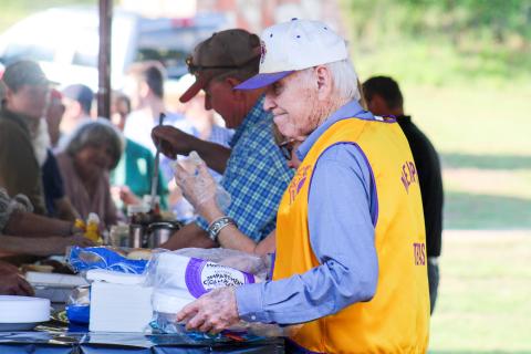 Memphis Lions Club members serve hamburgers at the 69th Annual Park Opener Friday, May 9 at Memphis City Park. ELIZABETH TANNER/THE GREENBELT INTREPID