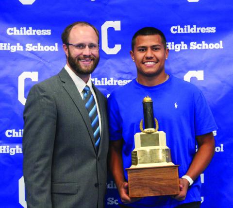 Isaiah Jalomo, right, accepts the Football Most Valuable Player award from Athletic Director and head football coach Bo Helm. The Red River Sun/Elizabeth Tanner