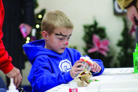 Garrett Pierce decorates a sugar cookie during Christmas In The Park’s Lighting of the Park festivities Saturday, Nov. 25 at Fair Park City Auditorium. The Red River Sun/Elizabeth Tanner