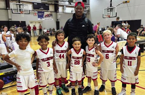 Wellington Elite team members Carmelo Coffee, left, Jaxon Coffee, Easton Ryan, Lincoln Mayer, Coach Prentice Coffee, Luke Roberson, Landry Mixon and Kase Reyes plan for their next basketball competition Saturday, June 17. The kindergarten through second-grade team competed in the Hoop 10 one-day summer wrap-up tournament at the Amarillo Netplex. Not pictured is Noah Peters. Courtesy Photo