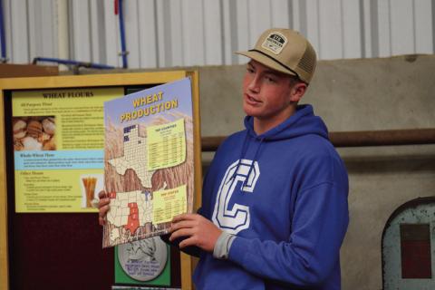 Childress High School sophomore Cutter Bruce shares wheat production facts, including the top-producing Texas counties and states, with area fifth-grade students at the 2023 Childress County Ag Day Wednesday, Nov. 1 at the Mashburn Event Center and Arena. The Red River Sun/Elizabeth Tanner