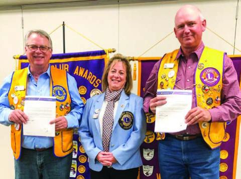 District 2-T1 Governor Deanna Porter presents Lion Neal Odom, left, a 15-year membership pin and Lion Rex Henard a 25-year membership pin during the Monday night, Nov. 17 meeting. The Red River Sun/Bev Odom