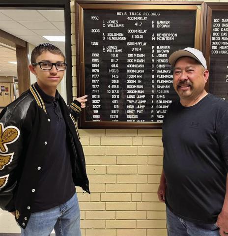 Memphis High School (MHS) junior Ryder Robison breaks the 3,200-meter school record with a time of 10:27.45 at the Bobcat Relays Thursday, March 23. Jesse Chavira, MHS Class of 1994, congratulates Robison on breaking his record time, which was recorded in 1992, 31 years ago. Photo Courtesy of Memphis ISD