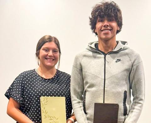 Eryn Torrez and Armando “Tiny” Hinojosa receive recognition and accept their bibles during the Sunday evening, May 11 service at Trinity Fellowship Church.