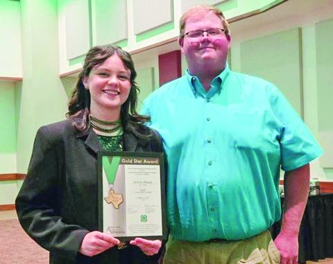 A senior at Memphis High School, Jordyn Altman accepts the Gold Star Award at the recent District 1 Gold Star Banquet in Canyon. She is congratulated by Hall County AgriLife Extension Agent J.D. Schnitker. The Gold Star Award is the highest achievement award given by the Texas 4-H Youth Development Program through the County 4-H Program. Courtesy Photos