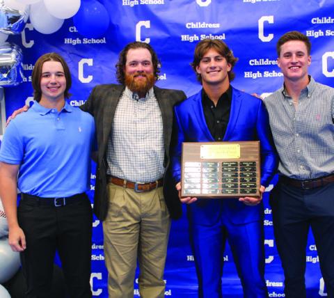 Head baseball coach Jonathan Wise, second from left, awards Bobcat Baseball Offensive Most Valuable Player (MVP) Scout Smith, second from right, and Bobcat Baseball Co-Defensive MVPs Aiden Allen, right, and Sawyer Dunlap, left.