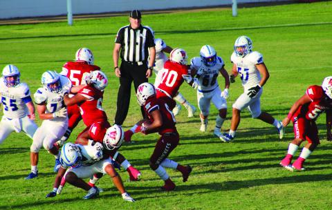 Skyrocket running back Dakota Marshall (6) runs the ball down field as teammates Fabian Pina (65), Blake Strickland (50), Rey Ramirez (77), Tryston O’Rear (70) and Ramon Rodriguez (51) fend off the Eagles Friday night, Sept. 2 on home turf. The Red River Sun/Shauna Salinas