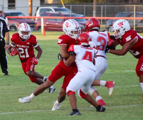 Skyrocket Travon Lewis (21) attempts to run the ball with Anthony Ortiz (15) and Israel Acosta (52) blocking the way. The Red River Sun/Shauna Salinas