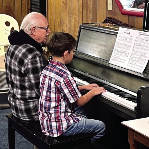 Monson Music Studio’s Benjamin Guajardo, a third-grade student at Childress Elementary School and the nine-year-old son of Jake and Stephnie Guajardo, entertains Thursday, Nov. 13 at the Childress Senior Citizens Center. In honor of Veterans Day, Guajardo, accompanied by Monson Music Studio owner and instructor Gerald Monson, performed five patriotic songs on the piano, including “America,” “Marines’ Hymn,” “Anchors Aweigh,” “Yankee Doodle” and “The Cassion Song.”