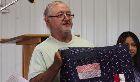 Veteran James Gray, U.S. Army Sergeant First Class, receives the second-ever Childress County 4-H Quilt of Valor at the Childress Elks Lodge #1113 Memorial Day Service Monday, May 26 at Jones Chapel in Childress Cemetery. The Red River Sun/Elizabeth Tanner