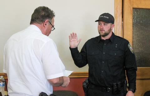 Childress Police Chief Jerrald Johnson swears in new officer Preston Bradley during the Childress City Council meeting Wednesday, March 25 at Childress City Hall. Bradley was joined by his family, including wife Kalin Bradley who pinned on his badge. The Red River Sun/Elizabeth Tanner