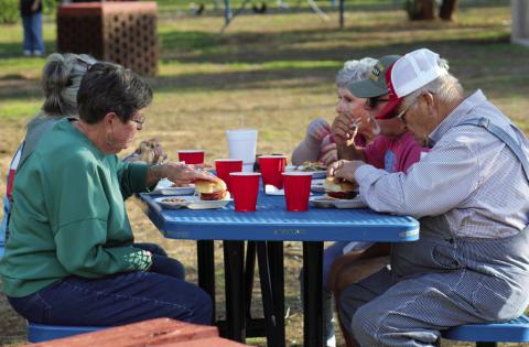 Attendees gather for barbecue hamburgers, including baked beans and iced tea, at the 69th Annual Memphis Lions Club Park Opener Friday, May 9 at Memphis City Park. The Red River Sun/Elizabeth Tanner