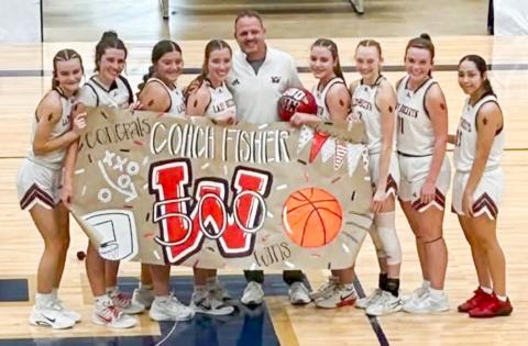 The Lady Rocket basketball team celebrates Coach Shannon Fisher’s 500th career win to highlight the Lady Rockets’ 55-22 semifinal victory on Tuesday afternoon, Dec. 30 at the TexasBank Holiday Classic in Brownwood. From left: Kambrie Fisher, Brynlee Proffitt, Eryn Torrez, Bryn Phillips, Coach Fisher, Gannon Guy, Taytum Kane, Ceighley Killian, Aundrea Garcia. Wellington High School