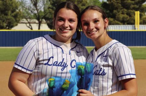 Childress Lady Cats Kaidie Hackler, a three-year varsity catcher and first baseman, and Jena Preston, a four-year varsity pitcher, are celebrated during senior night Friday, April 21. Playing the Abernathy Lady Lopes, the Lady Cats picked up an end-of-season 16-6 win. Courtesy Photo