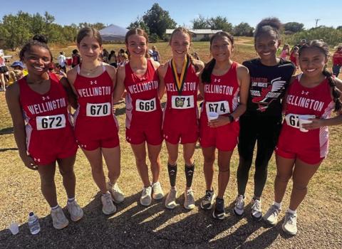 The Wellington Lady Rocket cross country team, including, from left, Aleah Lewis, Anna Henard, Addalyn English, Taytum Kane, Leslie Orozco, Angela Lewis and Sabrina Segovia, take their first team championship of the season at the Guthrie Rattlesnake Run Wednesday, Sept. 11. Courtesy Photo