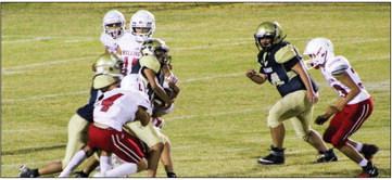 Junior varsity Skyrocket Noah Cantu (4) tackles a Memphis Cyclone with Anthony Ortiz (15), TJ Salinas (11) and Joey Orozco (33) rushing in to assist. The Rockets remain undefeated on the season, winning by a final score of 50-6. The Red River Sun/Shauna Salinas