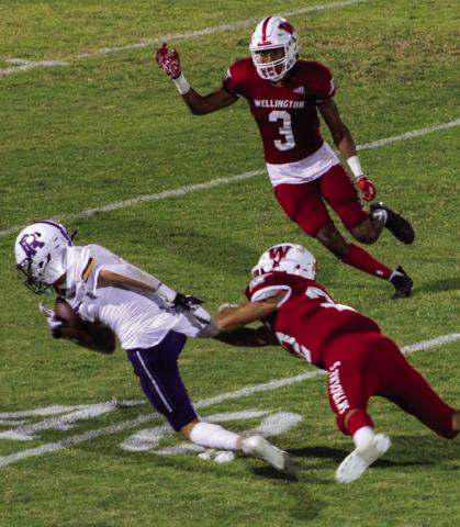 Enrique Jaimes (22) attempts to stop the Wildcat ball carrier while Jordan Nation (3) comes in to bring him down in the homecoming victory against River Road 42-0 last Friday, Sept. 9. The Red River Sun/Shauna Salinas