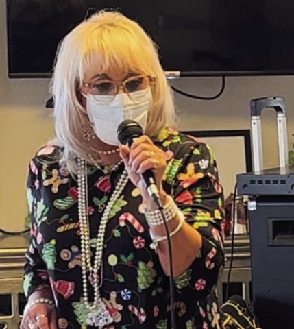 Vocalist Melissa Kiker sings 16 Christmas selections at Wellington Care Center Sunday afternoon, Dec. 11. She always considers entertaining the residents a blessing. Her husband, Lon Kiker, assisted her with the music, and her daughter, Grace Kiker, attended as well. Courtesy Photo