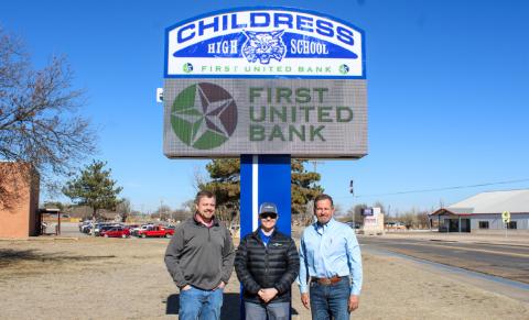 Childress Independent School District (ISD) Superintendent Mark Dykes, right, thanks First United Bank Vice President Taylor Thornton, left, and First United Bank Assistant Vice President and Childress Branch Manager Alabama Bohannon, middle, for the new digital marquee, located on the Childress High School campus. The Red River Sun/Elizabeth Tanner