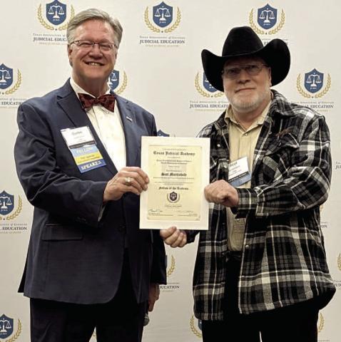 Lubbock County Judge Curtis Parrish, representing the Texas Association of Counties, presents Collingsworth County Judge Scot Martindale his Fellow of the Academy certificate. Texas Association of Counties