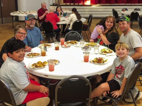 As servings of chocolate, strawberry and lemon sheet cake line the stage of the Bura Handley Community Center, families partake in the Wellington Lions Club Fiesta Pile-On Fundraiser from 5-6:30 p.m. Friday, Nov. 7. The Lions appreciate the overwhelming support of the community. Clockwise, from left: Layton Wynn, Stacey and Michael Breedlove, Charlotte, Cari-Anna, Matt and Stratton Wynn. In the background are Ray and Phyllis Floyd, Carolyn Keller and D’Lyn Faulks. The Red River Sun/Bev Odom