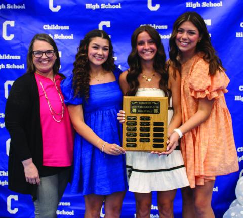 Head volleyball coach Misty Roark, left, awards Volleyball Co-Offensive MVPs Journey Prince, right, and Kaydence Simpkins, second from left, and Volleyball Defensive Most Valuable Player (MVP) Chloe Churchill, second from right.