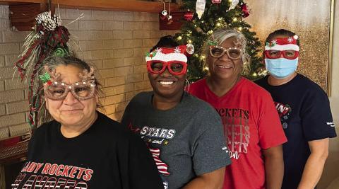Getting ready for the holiday season, certified nurse aids at Wellington Care Center line up in front of the fireplace. Courtesy Photo