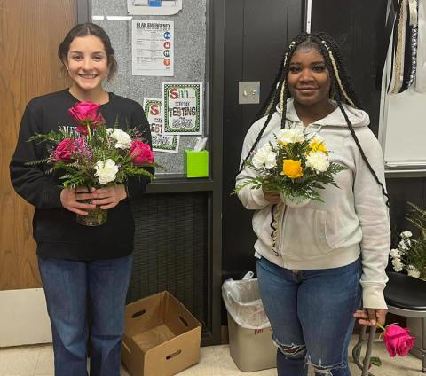 Floral design students create multi-flower bud vases, mug arrangements