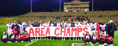 Following a 48-0 Area Championship win over the Sudan Hornets, the Wellington Skyrockets gather for a moment of glory before preparing for the next opponent. Photo Courtesy of Wellington High School