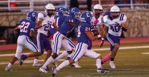Childress’ Nick McMinn gains yardage for the Bobcats, while Lamont Nickleberry (14), Mark Willis (21) and Aiden Allen (22) block out the Spearman Lynx defense during Childress’ 41-7 win Friday, Oct. 21 at Fair Park Stadium. The Red River Sun/Nicole Dill