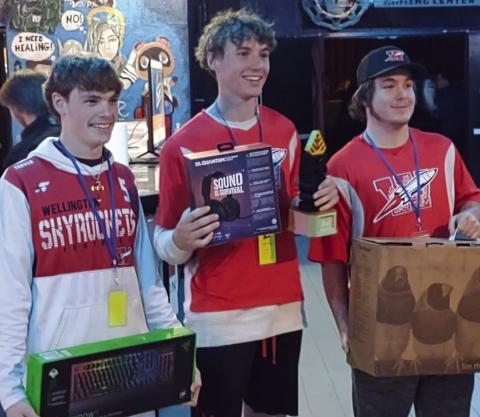 Rocket League team members, including juniors Carson Tarver, left, and Nixon Folk and sophomore Caleb Strickland, receive first place at the Region 16 eSports Invitational.