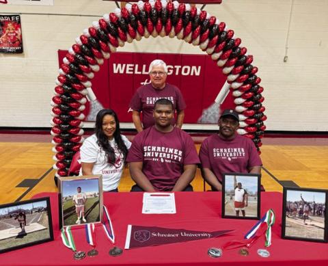 Wellington High School senior Jovani Munn signs a National Letter of Intent to continue his track career at Kerrville’s Schreiner University Friday, May 9. From left: mother and step-father Hope and John O’Rear; Munn; father Joe Bill Munn. Wellington High School