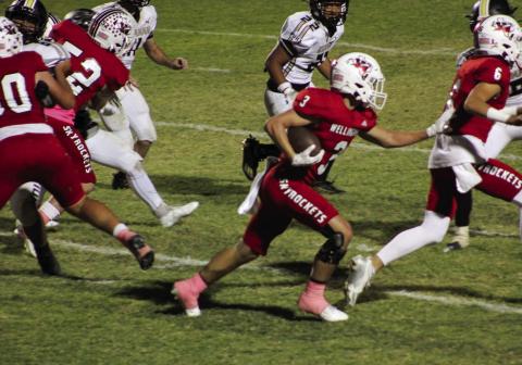 Wellington’s offensive line, including Major Brown (6), Hunter Hedrick (52) and RJ Granadoz (60), blocks a path for Gunner Guy (3) during the Rocket’s 49-6 win over Quanah Friday, Oct. 18 at Powell Field in Wellington. The Red River Sun/Shauna Salinas