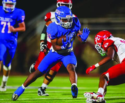 Childress’ Lucian Davis stiff arms a Friona defender during the Bobcats’ district opening win over the Chieftains Friday, Oct. 11 at Fair Park Stadium in Childress. Press Pass Sports/David Erickson