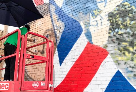 Muralist Malcom Byers adds shading to the nostrils of the Duke of Wellington with his spray paint technique Tuesday morning, Aug. 26. As he nears completion of his Wellington mural masterpiece, he lacks about a week finishing and touching up his artwork on the south side of 915 West Ave., just next to Wellington City Hall. The Red River Sun/Bev Odom