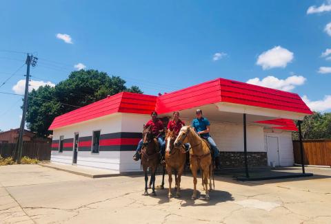 Wellington High School students Jasmin Moreno, left, Eryn Torrez and Ellie Thomas can’t pass up a My T Burger ice cream treat as they warm up their horses for the upcoming Wellington Fourth of July Rodeo. The Red River Sun/Bev Odom