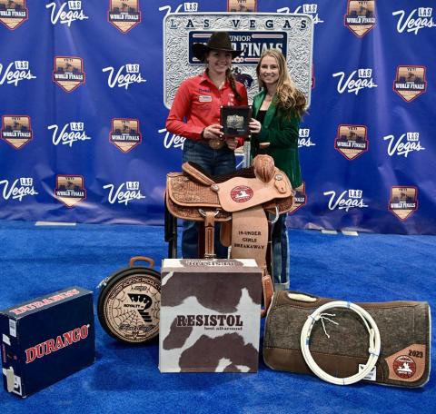 Tell’s Colee Cox, 16, takes home the 19-and-under girls breakaway roping championship at the Junior World Finals Saturday, Dec. 9 in Las Vegas, Nev. She is congratulated by Junior World Finals Assistant General Manager Brilynn Bentley. Courtesy Photos