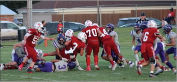 Skyrocket Gatlin Guy (3) runs the ball down field as Caleb Strickland (50), Israel Acosta (52), Tryston O’Rear (70), Ethan Nevarez (44) and Dakota Marshall (6) fend off the 3A Spearman Lynx during Wellington’s 12-6 homecoming victory last Friday night, Sept. 15. The Red River Sun/Shauna Salinas
